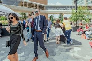 People socializing and walking around the Encore Terrace at RBC Place London during an Encore Terrace Summer event.