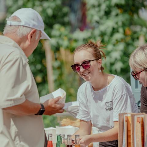 Food vendors selling tasty treats to visitors at Tunes on the Encore Terrace Event