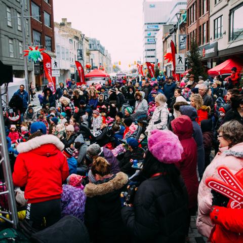 Dundas place with a crowd celebrating and cheering