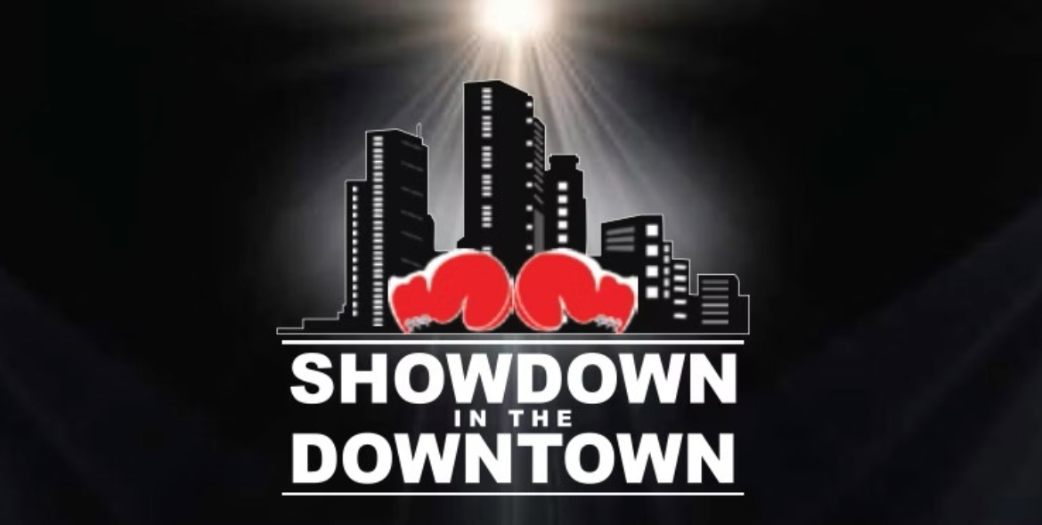 Two red boxing gloves in front of a city skyline with bright light shining above and the text 'Showdown in the Downtown'.